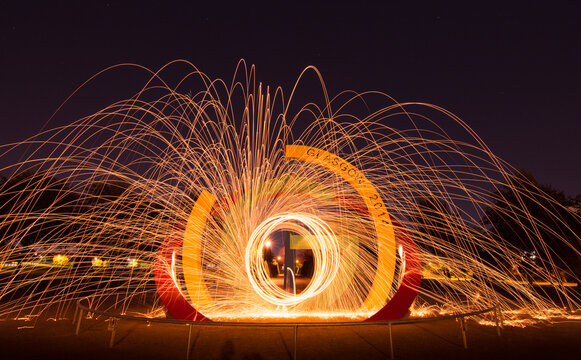 Dramatic sparks fly from the 2014 Commonwealth Games Monument - Long exposure image - Glasgow, Scotland