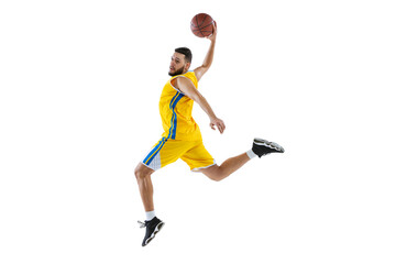 Dynamic portrait of professional basketball player jumping with ball isolated on white studio background. Sport, motion, activity, movement concepts.
