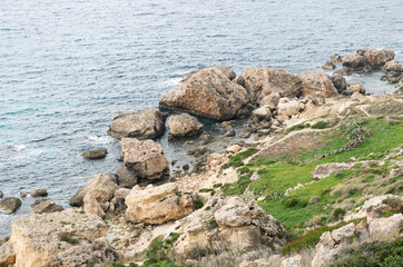 Close up of rocks and blue waves at the shore of Manikata, Malta