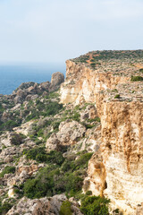 Fototapeta na wymiar The rocks at the rough coast of the Mediterranean sea near Manikata, Malta
