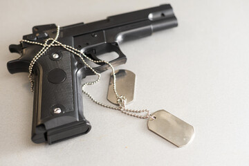 Pistol on table, gun with dog tags