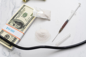 Drug heroin, syringes, money, guns on a dark background copy space, concept of crime and addiction