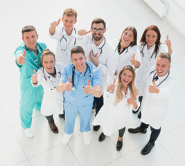 Fototapeta na wymiar group of smiling medical professionals giving a thumbs up
