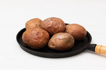 Five baked jacket potatoes white background