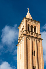 Fototapeta na wymiar Marsakala, Malta - 01 07 2022: Tower of the church against a blue sky