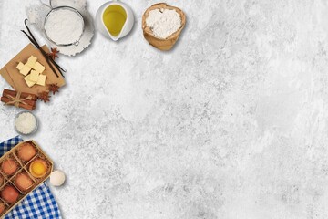 plate with wheat flour and ingredients for making dough for homemade cookies on a desk