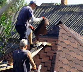 the roofer is going to glue the soft tiles to the roof surface of the gazebo