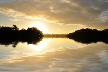 Sky reflections on lake at sunset