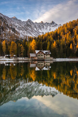 Autumn landscape of lake Nambino with hute, Madonna Di Campiglio, Trentino, Italy.