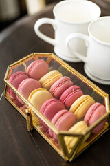 Pink French Macarons in Gold and Glass Box, Valentine's Day Dessert, Fancy Dessert, White Coffee Cups, Copy Space