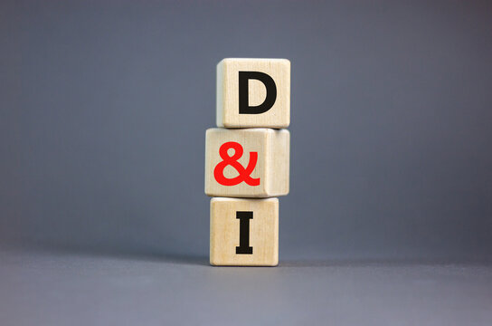 D and I, Diversity and inclusion symbol. Concept words D and I, diversity and inclusion on wooden cubes on beautiful grey table grey background. Business, D and I, diversity and inclusion concept.