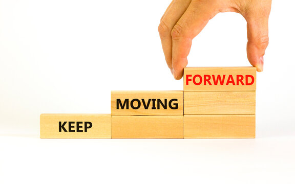 Keep moving forward symbol. Concept words Keep moving forward on blocks on beautiful white table white background. Businessman hand. Business, motivation and keep moving forward concept. Copy space.