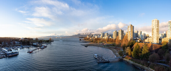 Aerial View of Modern City with a beach on the West Coast Pacific Ocean. Sunny Winter Sunset. False Creek, Downtown Vancouver, British Columbia, Canada. Panorama