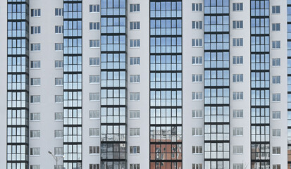 Close up of new residential high-rise building with many windows - obrazy, fototapety, plakaty