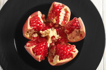 cut pomegranate fruit close-up and visible pomegranate seeds