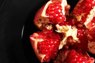 cut pomegranate fruit close-up and visible pomegranate seeds
