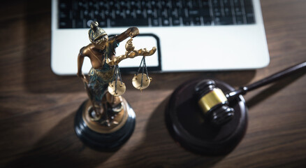 Lady Justice Statue with a judge gavel and computer.