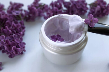 Cream with lilac extract on a light background