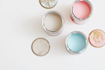 Top view of open paint tin cans on white background.