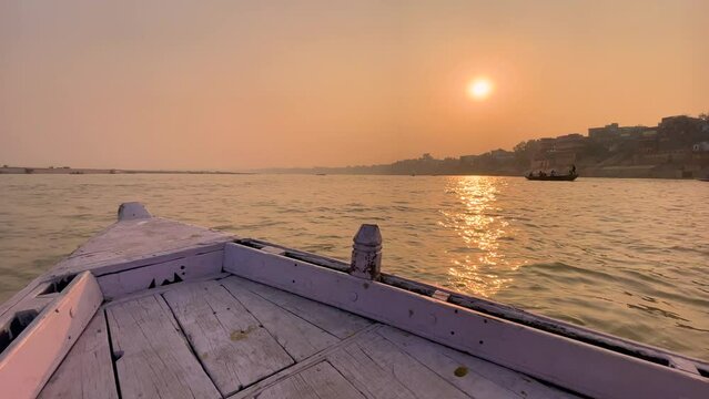 Boat moving during sunset or sunrise in the Ganga river at Varanasi Ghat
