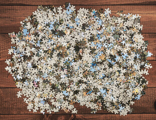 A set of puzzles thrown out on the table in a heap.