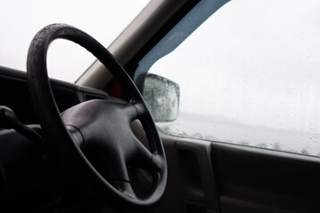 interior of a camper van looking out through wet rainy windows 