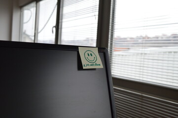 message on the monitor in the office, smiling face and job well done, support and motivation for successful and good work, concept