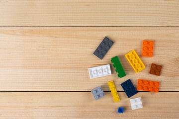 Plastic blocks of a children's designer on a wooden table.