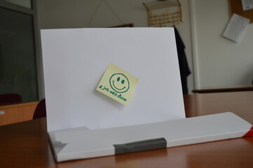 workbook with the message job well done and a smiling face, on the office desk, support and a positive response to good work, concept