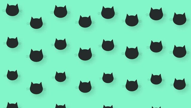 Colorful pattern of black cat heads on green background. Seamless pattern with cat faces. Top view. Animal silhouette. 4K video motion