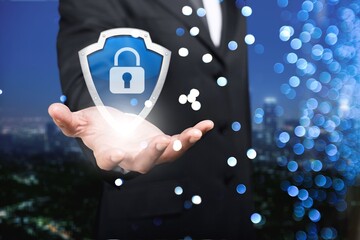 Businessman holding a shield with a padlock on a worldwide networking connection, Data protection and security