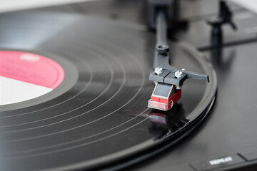 Fototapeta na wymiar Record player playing a vinyl record. Black platter