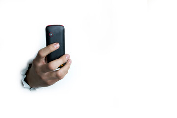 Push-button phone in hand on a white background.