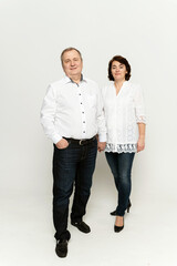 couple in national clothes on a white background. husband and wife in embroidered shirts. people of retirement age.