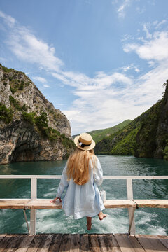 Blonde woman enjoying mountain view on a ferry