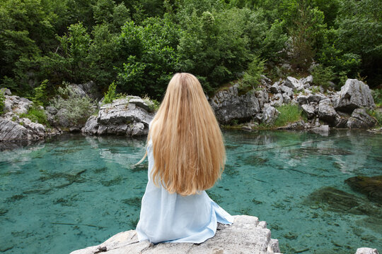 Blonde woman on a mountain lake in Valbone