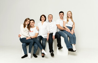 Obraz premium cheerful family on a white background. people of different ages and nationalities. family members. group portrait on white background
