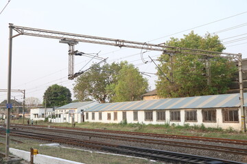 Railway electrification system. Power line wire over rail track. High metal construction transporting voltage energy.