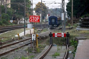End of rail road near railways station india with background of train coach passing