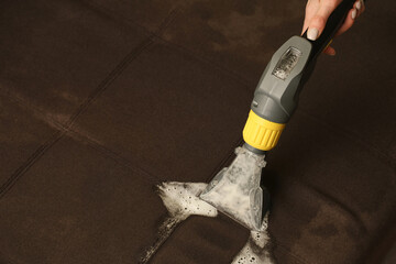 Deep professional cleaning of sofa with vaccum cleaner
