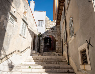 Fototapeta na wymiar Beautiful Rovinj steep, narrow streets with stone arches and medieval walls
