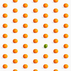 Seamless pattern of tangerines and one lime on a white background