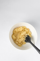 Melted butter and white sugar mixed in a white bowl