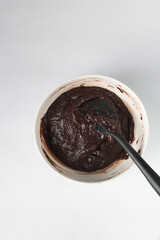Raw brownie batter in a bowl, Making brownies in a white bowl