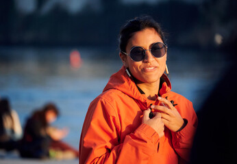 A shallow focus of a hip woman nose piercing having a nice day out by the Duero river in Portugal