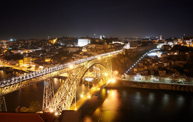Fototapeta na wymiar The illuminated Don Luis I bridge over River Douro at night in Porto, Portugal