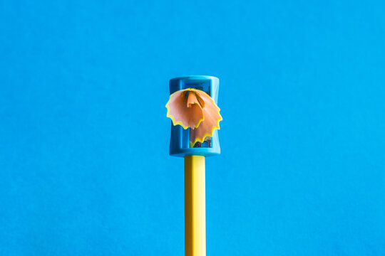 Creativity.
Yellow Pencil That Is Sharpened With A Manual Pencil Sharpener. Blue Background