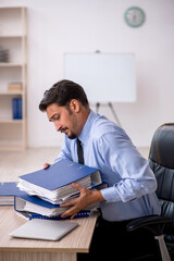 Young male employee working in the office