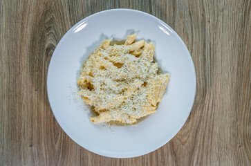 Penne pasta with parmegiano reggiano cheese top view