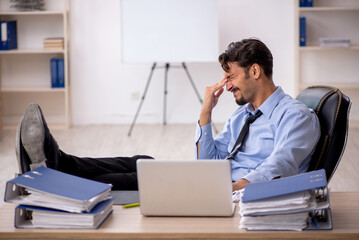 Young male employee working in the office